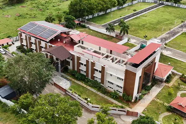 Aerial view of The Healing Hills Ayurveda and Naturopathy Centre campus in Coimbatore surrounded by lush greenery